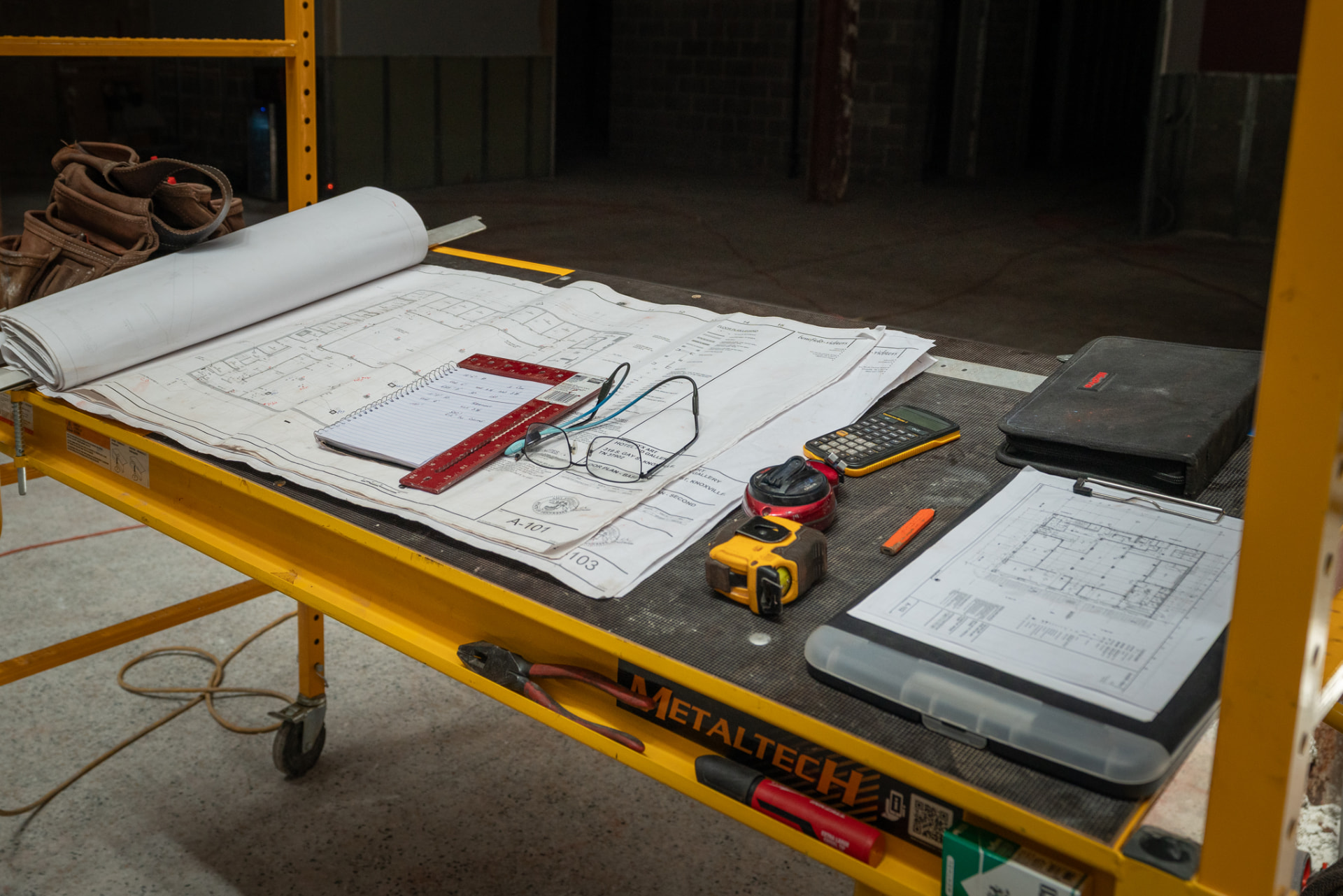 Construction plans and tools on site
